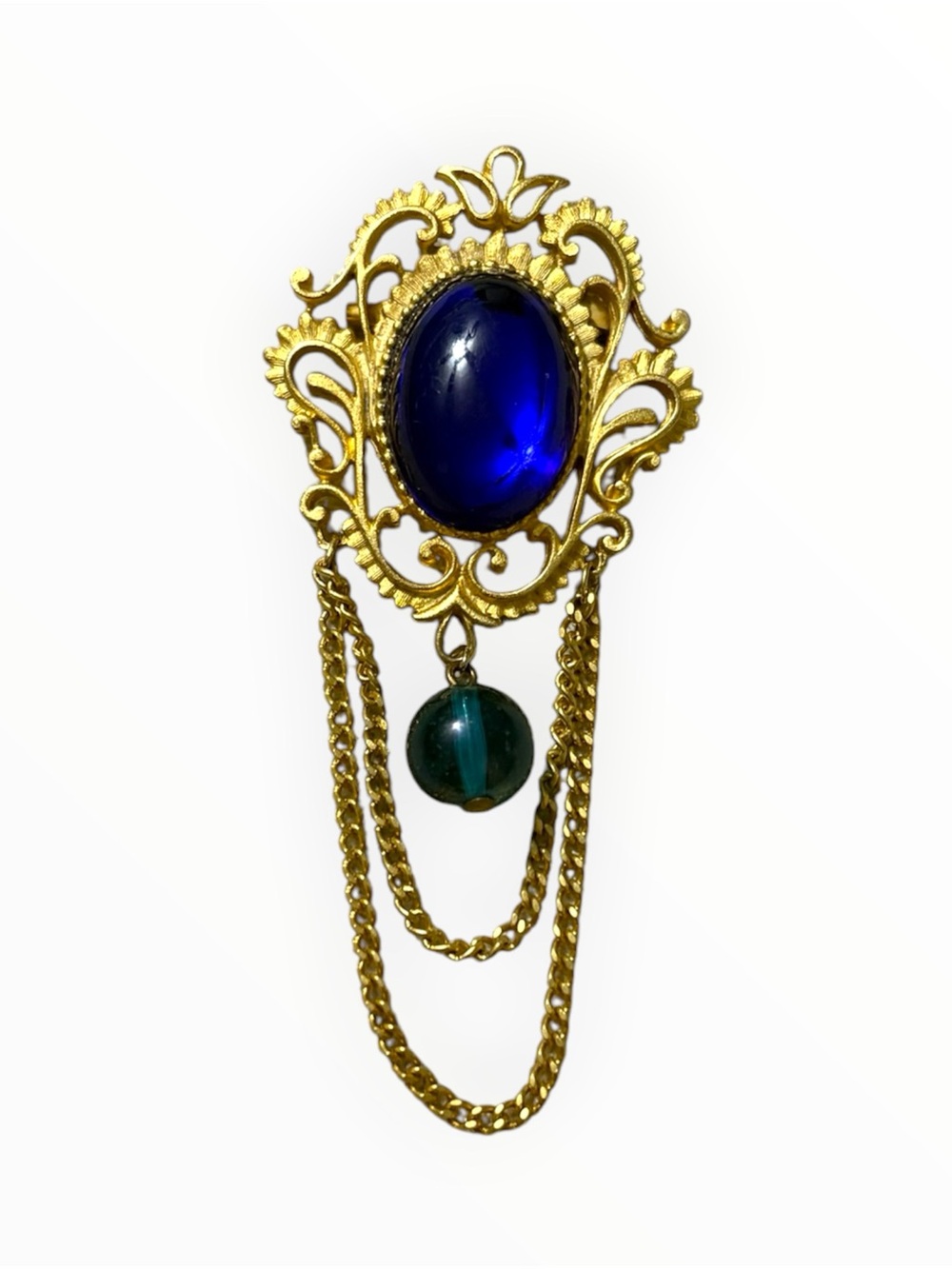 Gold Tone Filigree Brooch with Deep Blue Cabochon and Green Accent
